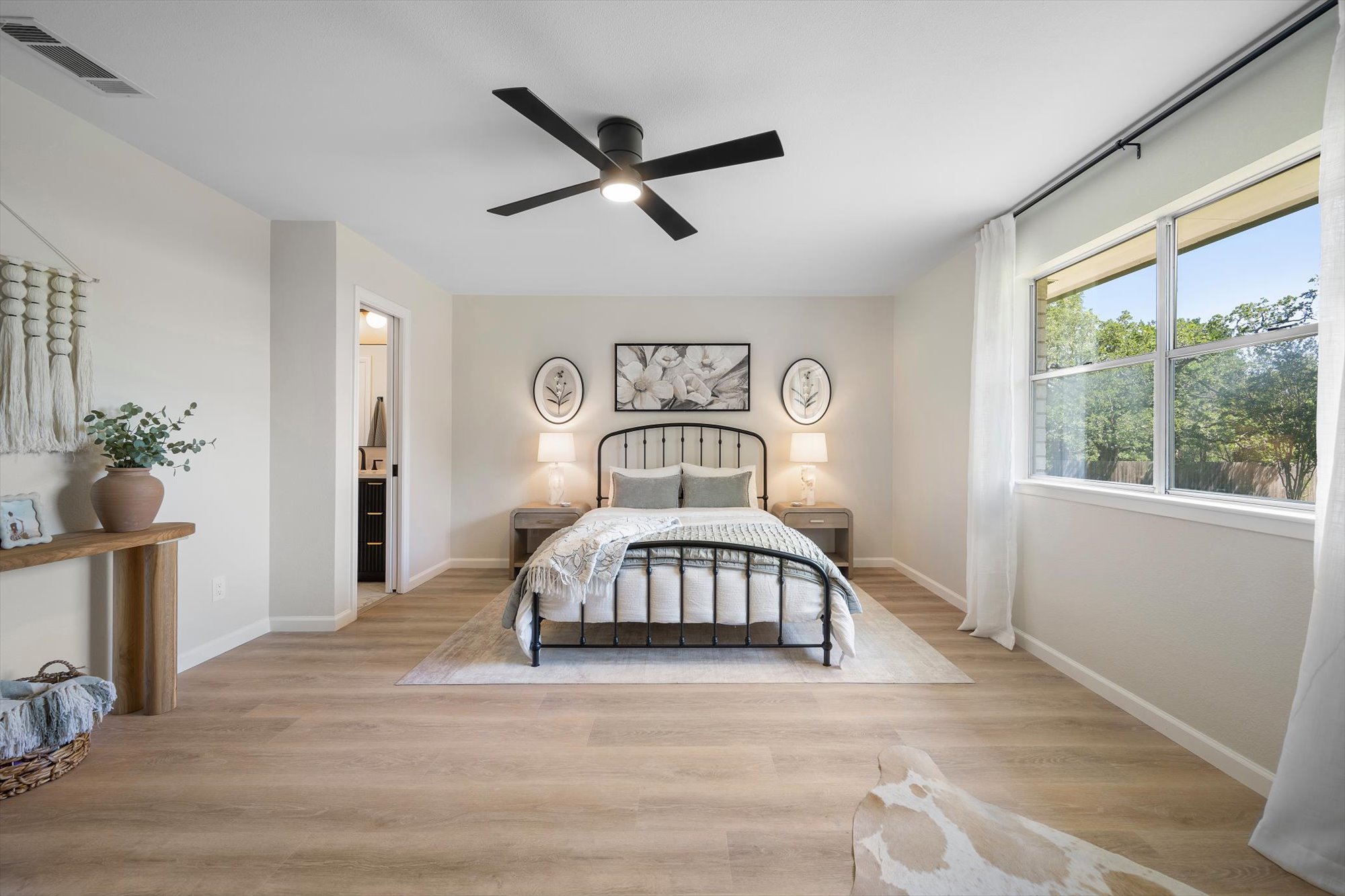 109 Woodland Road Georgetown, TX 78628 - Photo 21 of 40 Well-lit sleeping quarters with a stylish ceiling fan and durable plank flooring.