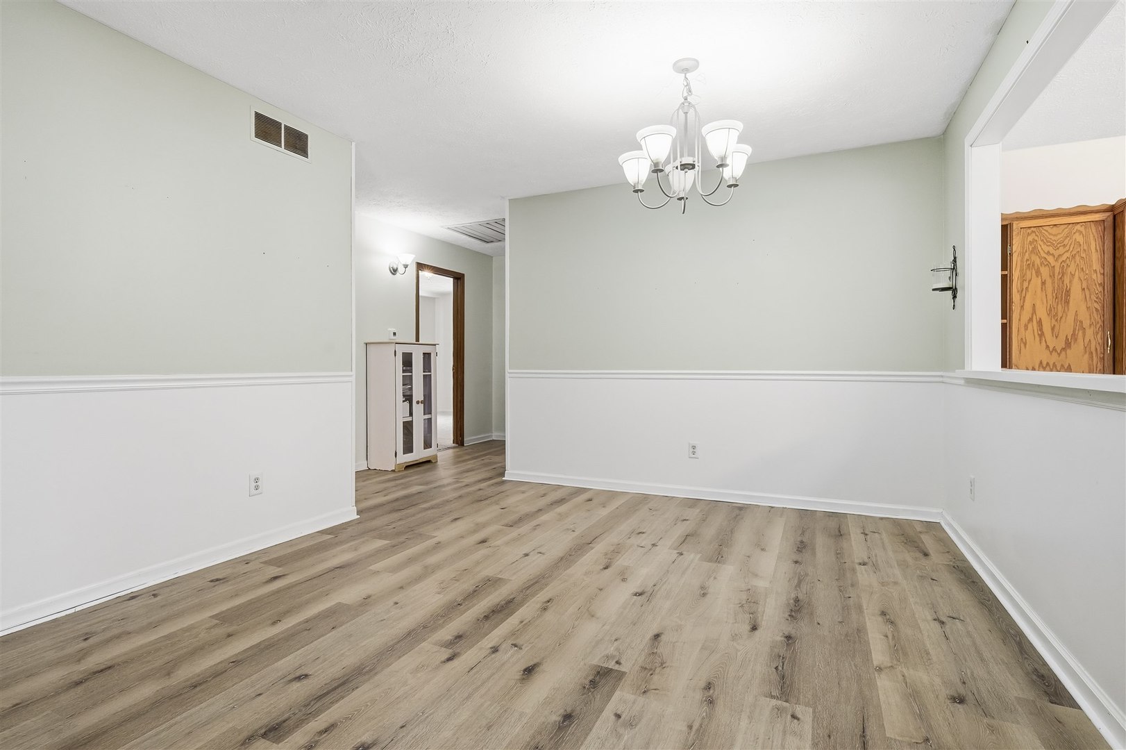108 Cardinal Drive Le Roy, IL 61752 - Photo 11 of 33 wooden floor in an empty room with a window