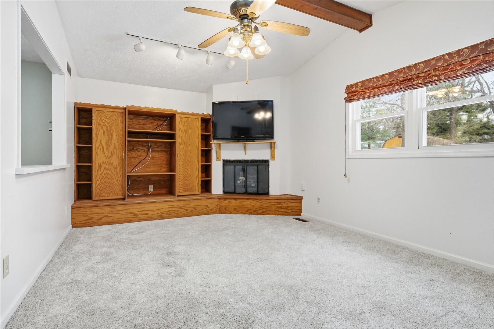 108 Cardinal Drive Le Roy, IL 61752 - Photo 12 of 33 a view of an empty room with fireplace and a window