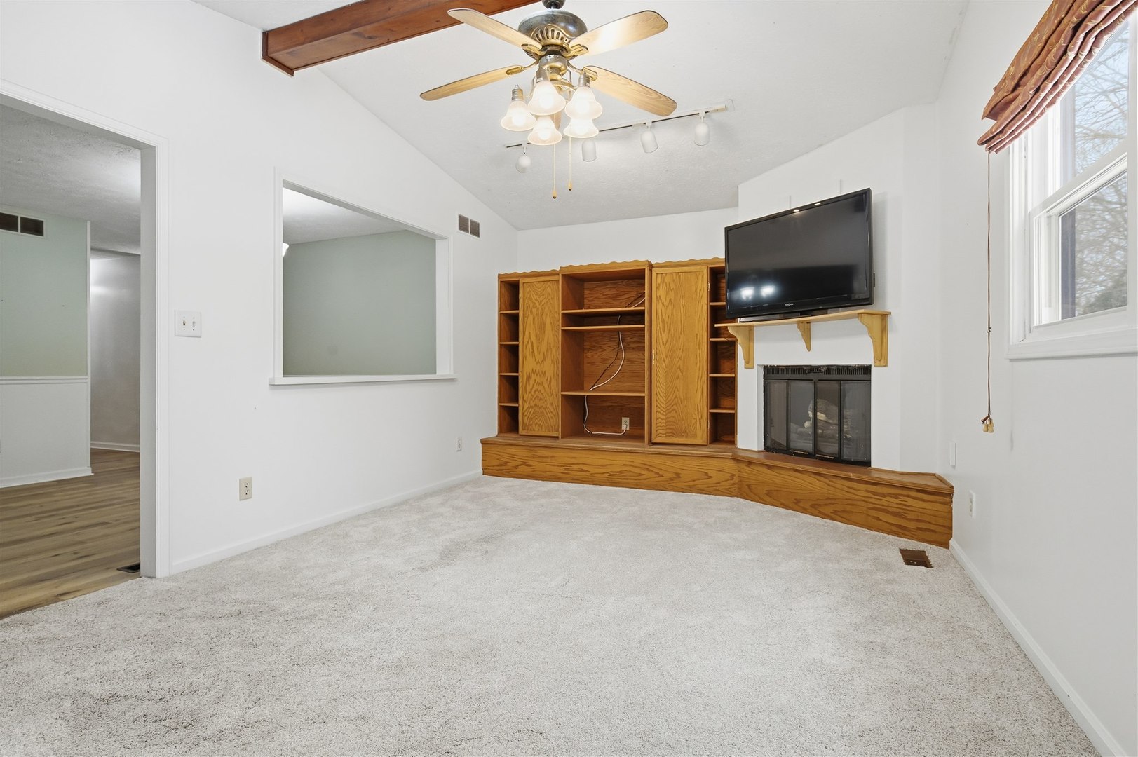 108 Cardinal Drive Le Roy, IL 61752 - Photo 13 of 33 an empty room with windows and fireplace