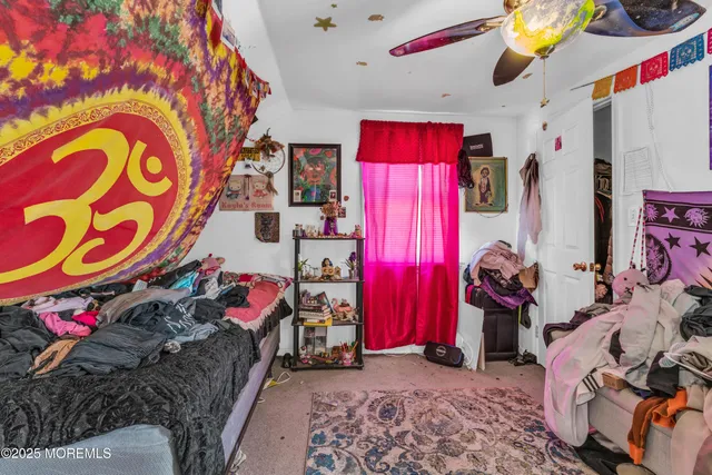 a view of a bedroom with clothes and shoes