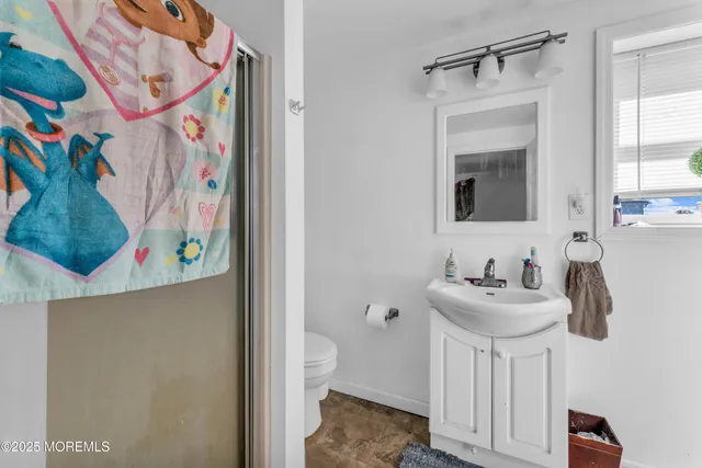 a bathroom with a sink a toilet and mirror