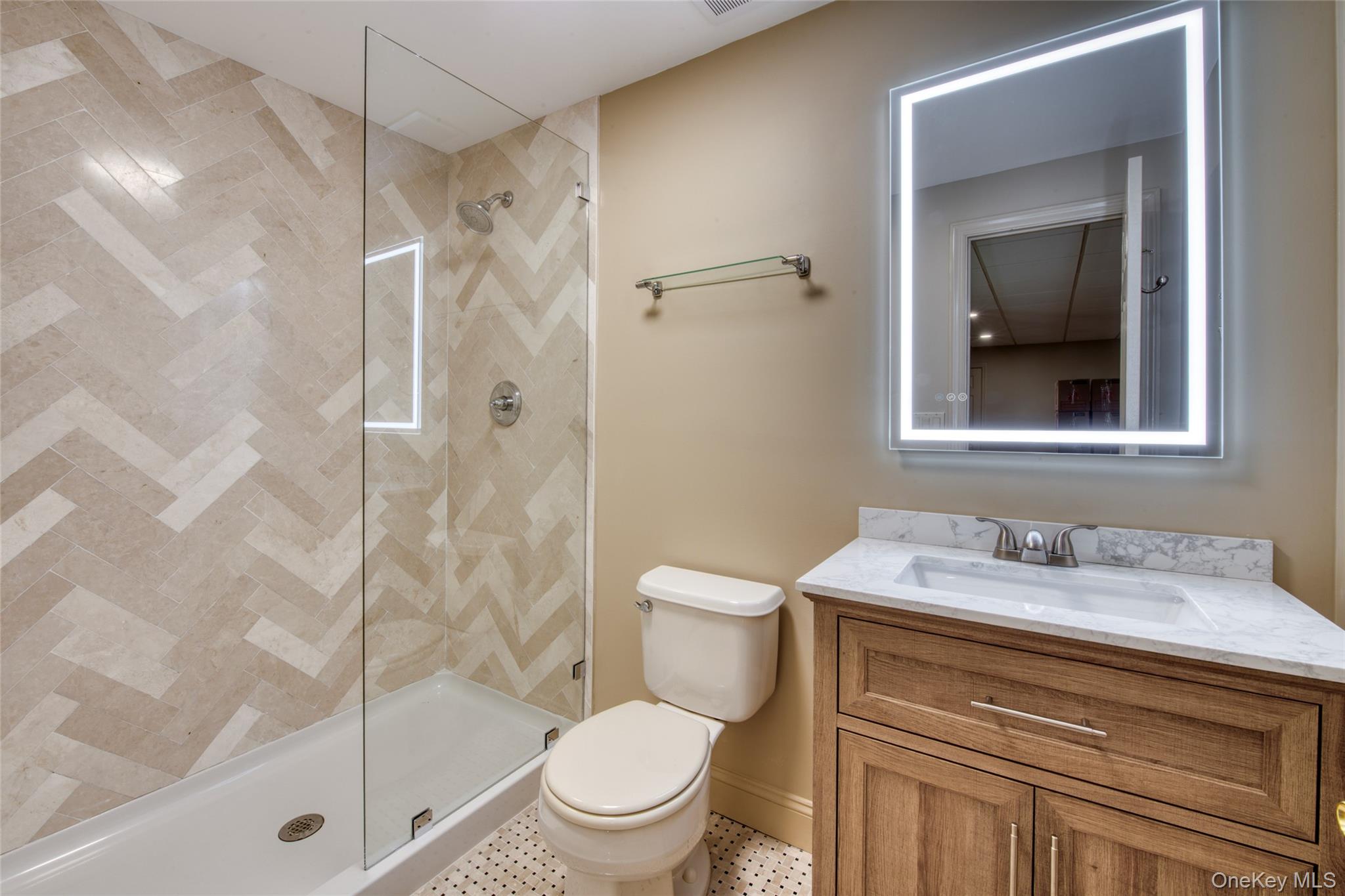 395 Stonecrop Road Riverhead, NY 11901 - Photo 24 of 40 Renovated Full bathroom featuring vanity and a tile shower