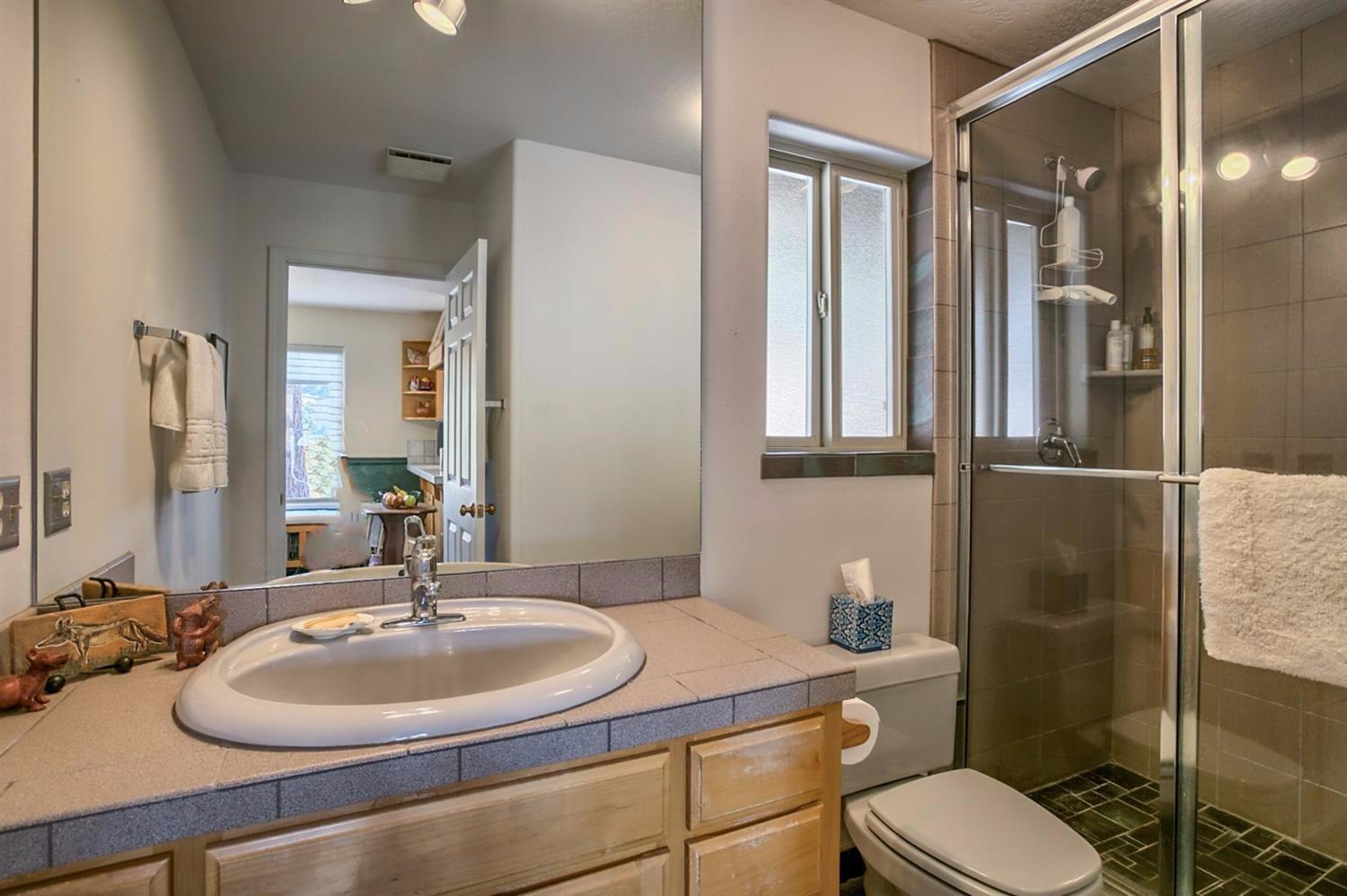 8009 Dead Indian Memorial Road Ashland, OR 97520 - Photo 17 of 24 a bathroom with a sink toilet and shower