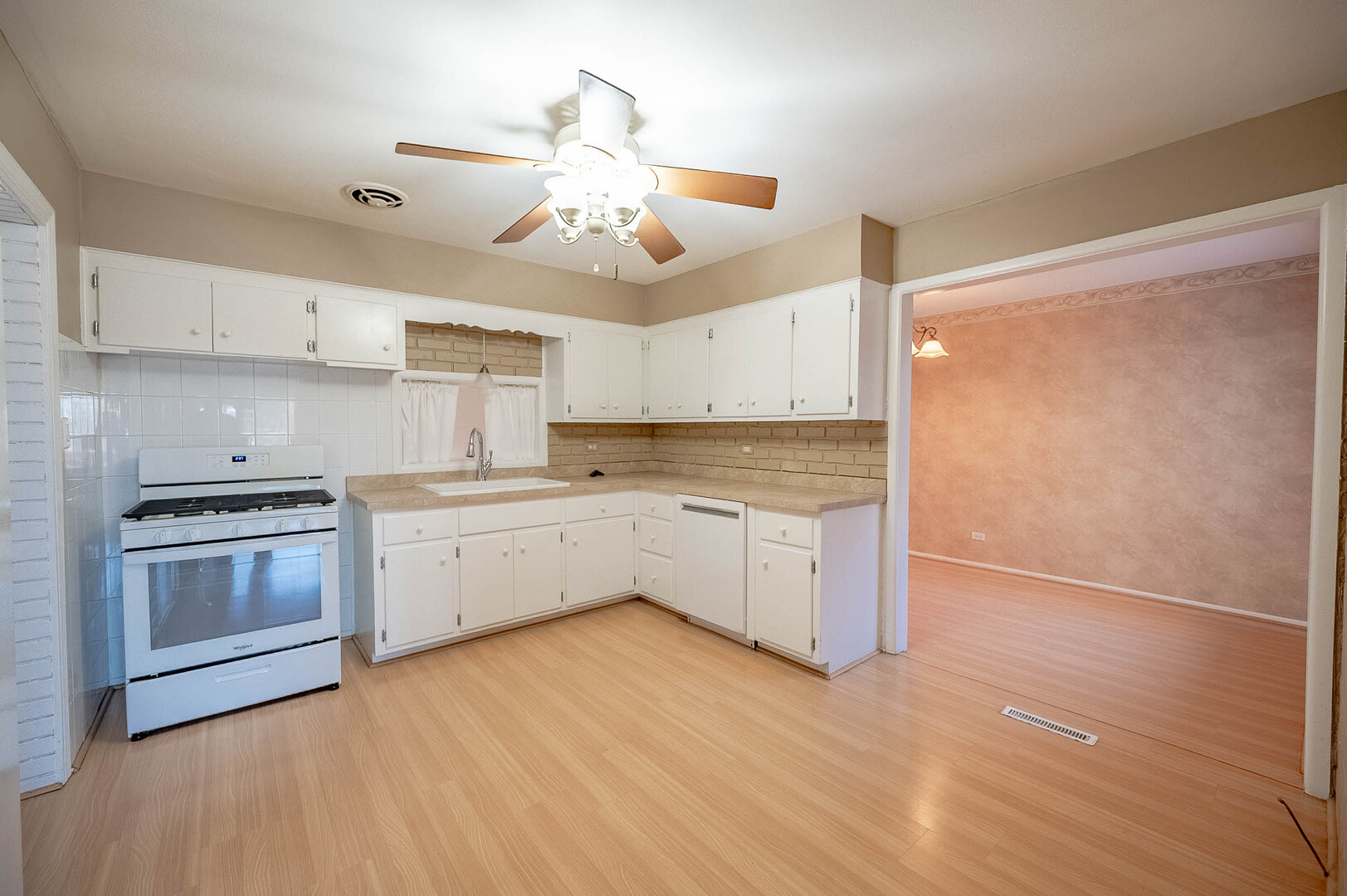 5919 West 109th Street Chicago Ridge, IL 60415 - Photo 5 of 14 a kitchen with stainless steel appliances white cabinets and wooden floors