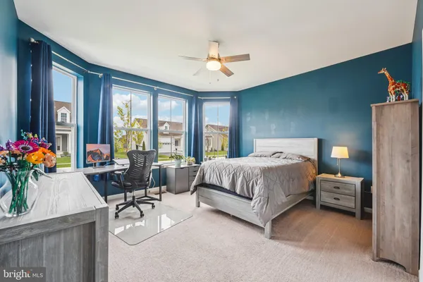 a spacious bedroom with a bed and a table