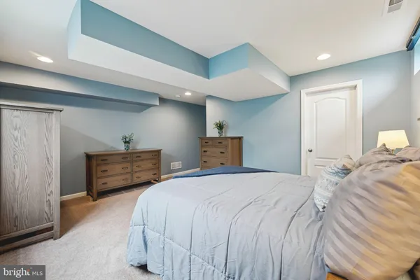 a bedroom with bed and wooden floor