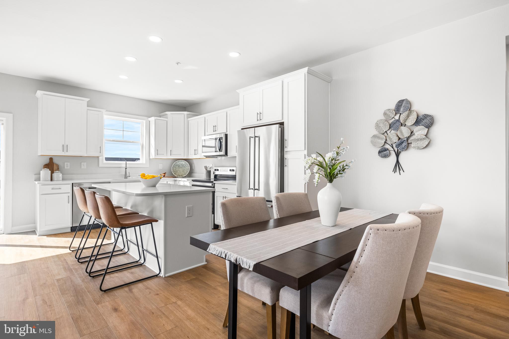 256 Ridgeview Lane, Unit 41 Hanover, PA 17331 - Photo 15 of 35 a kitchen with a dining table chairs and refrigerator