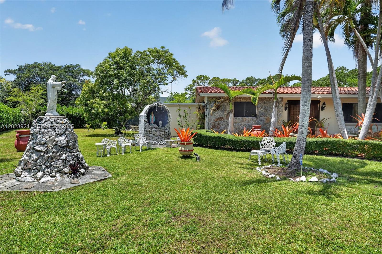 8461 Southwest 68th St Road Miami, FL 33143 - Photo 2 of 65 a front view of a house with swimming pool and garden