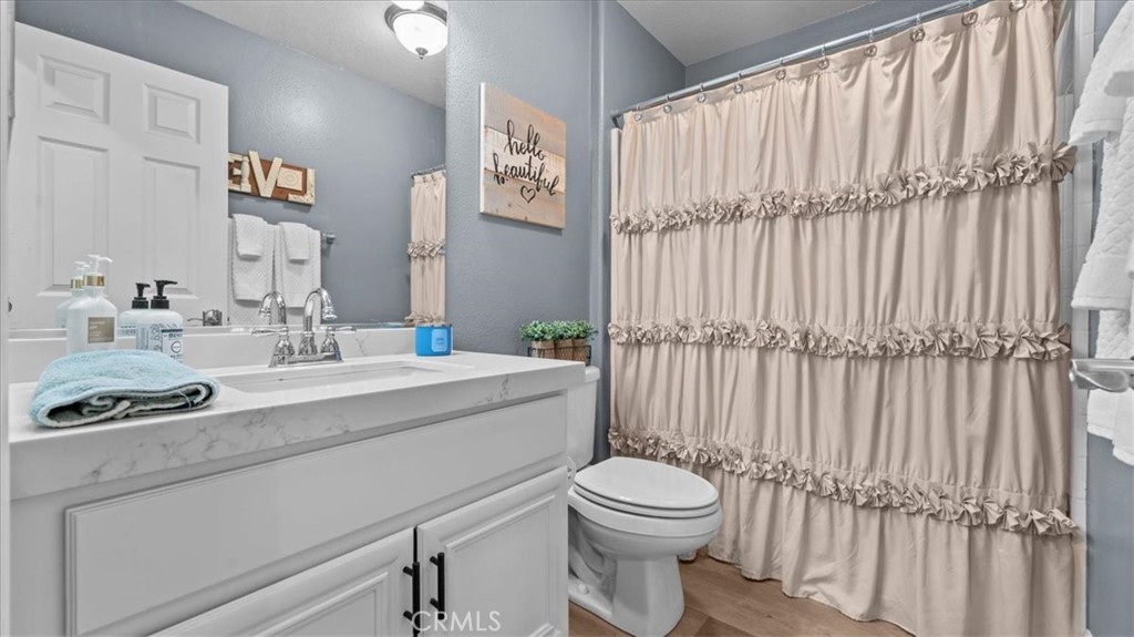 19829 Adirondack Lane Riverside, CA 92508 - Photo 10 of 34 a bathroom with a toilet a sink and a mirror