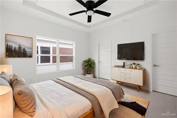 a bedroom with a bed and a flat screen tv