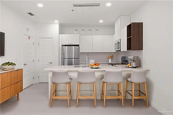 a kitchen with a sink cabinets and stainless steel appliances