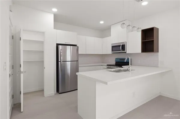 a kitchen with stainless steel appliances a refrigerator and a stove