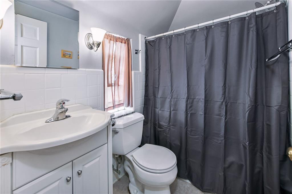 2019 Brookfield Road Pittsburgh, PA 15243 - Photo 11 of 18 a bathroom with a sink a toilet and shower curtain