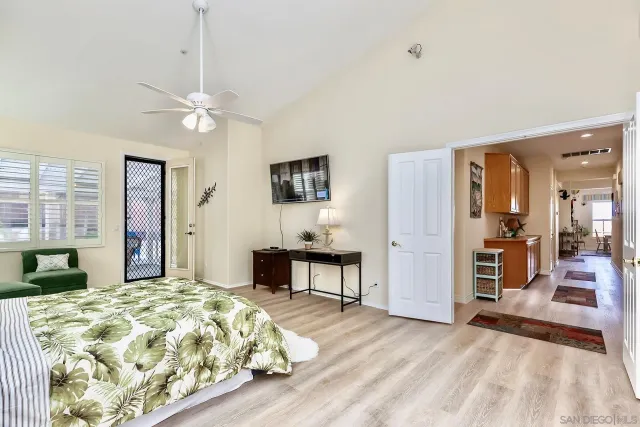 a bedroom with a large bed and a chandelier