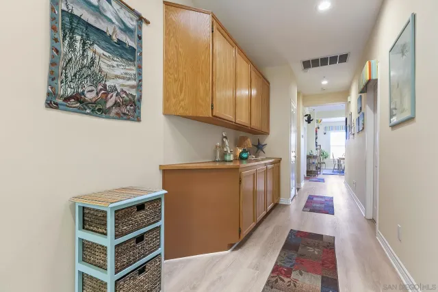 a view of a kitchen with wooden floor and a sink