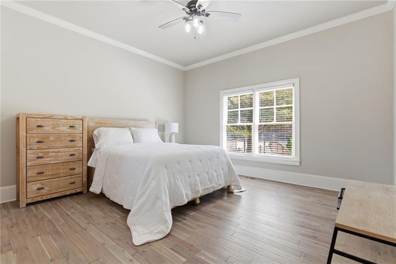 1565 Bramble Bush Way Suwanee, GA 30024 - Photo 13 of 62 a spacious bedroom with a bed and a window