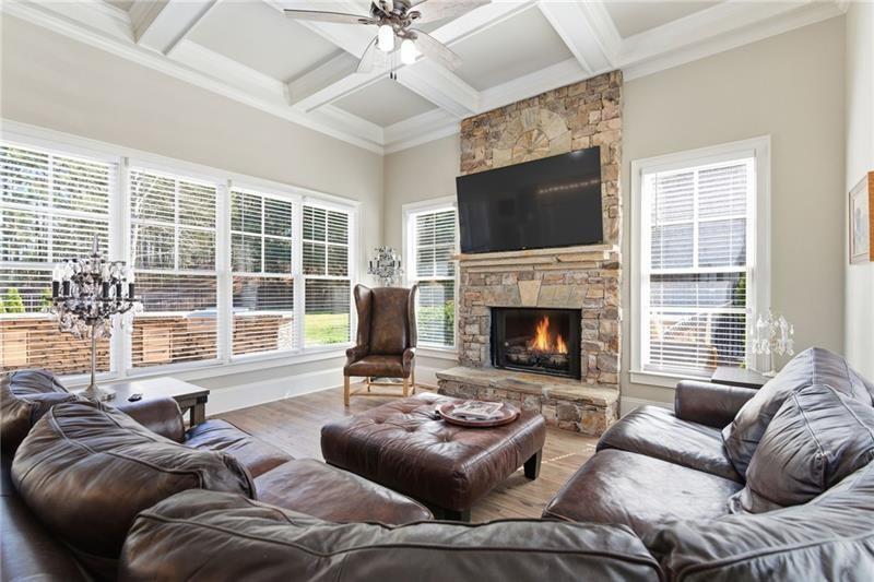 1565 Bramble Bush Way Suwanee, GA 30024 - Photo 20 of 62 a living room with furniture a large window and a fireplace