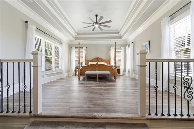 1565 Bramble Bush Way Suwanee, GA 30024 - Photo 29 of 62 a view of a livingroom with furniture window wooden floor and a ceiling fan