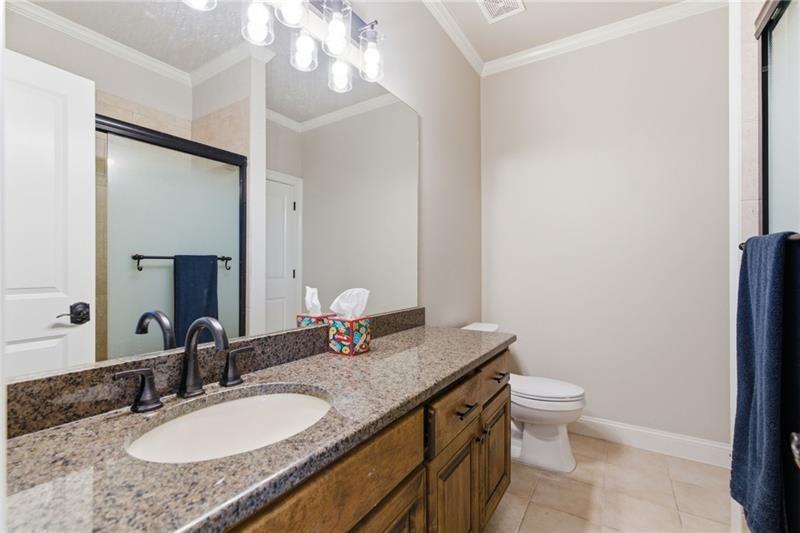 1565 Bramble Bush Way Suwanee, GA 30024 - Photo 39 of 62 a bathroom with a granite countertop sink and a mirror