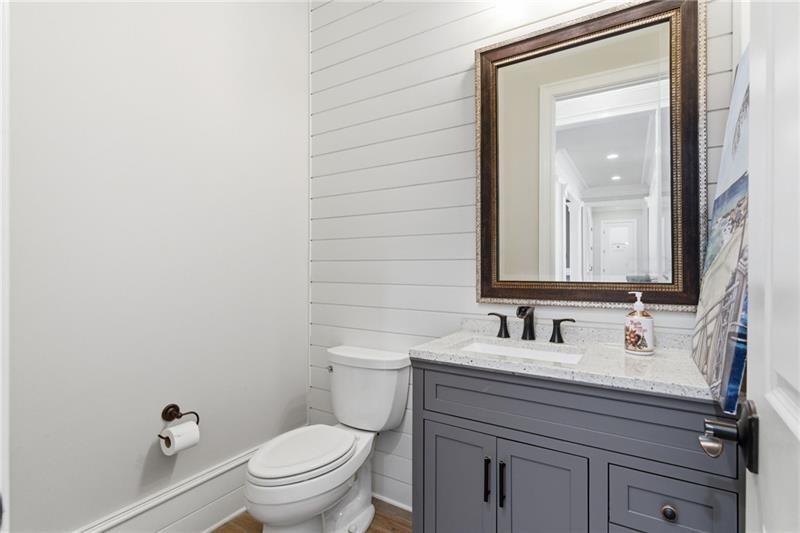 1565 Bramble Bush Way Suwanee, GA 30024 - Photo 43 of 62 a bathroom with a toilet a sink and mirror