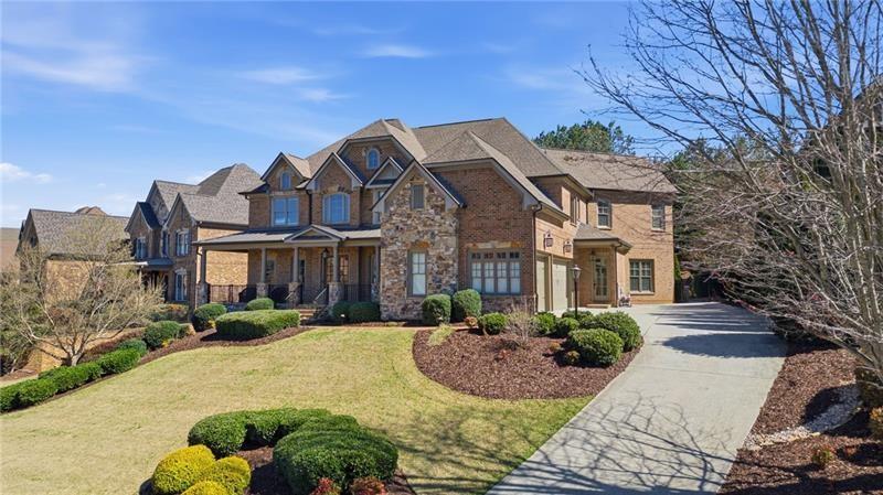 1565 Bramble Bush Way Suwanee, GA 30024 - Photo 44 of 62 a front view of a house with a yard and potted plants