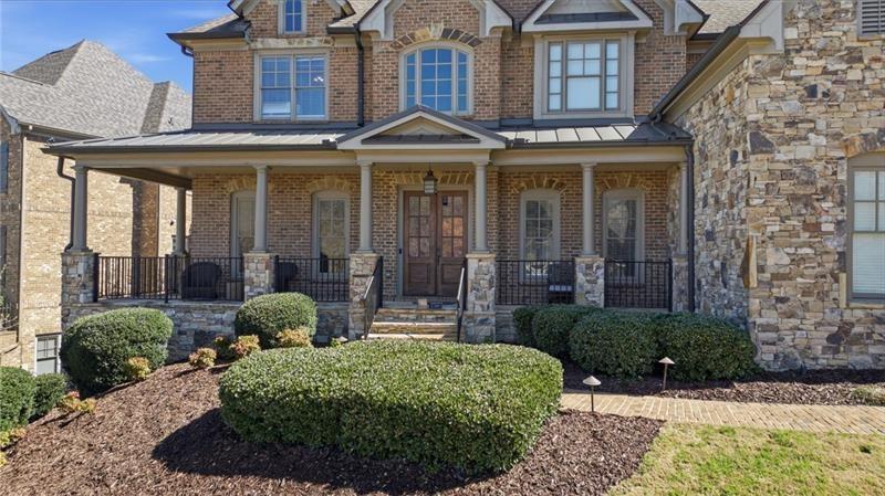 1565 Bramble Bush Way Suwanee, GA 30024 - Photo 45 of 62 a front view of a house with garden