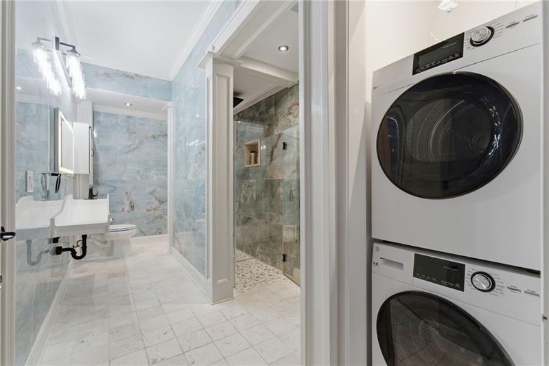 1565 Bramble Bush Way Suwanee, GA 30024 - Photo 52 of 62 a view of a bathroom with washing machine and dryer