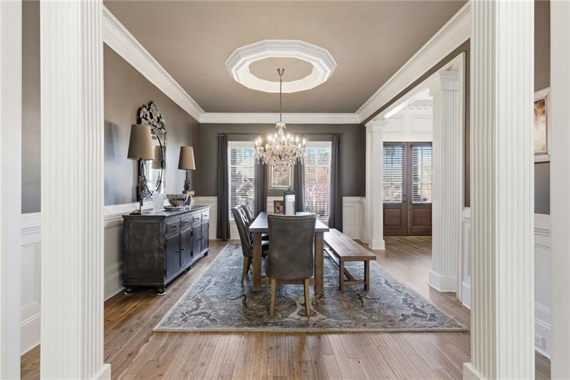 1565 Bramble Bush Way Suwanee, GA 30024 - Photo 6 of 62 a dining room with wooden floor and a floor to ceiling window