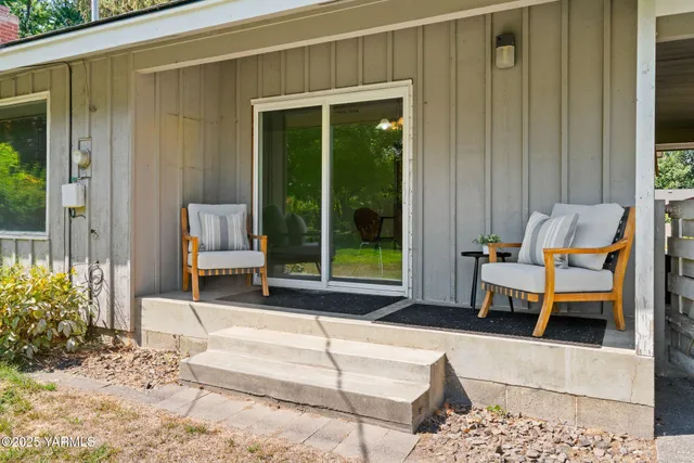 a view of a two chairs in the balcony