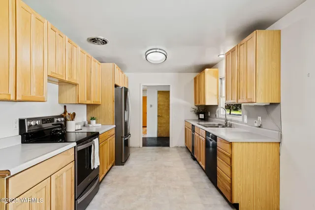 a kitchen with a sink a stove and cabinets