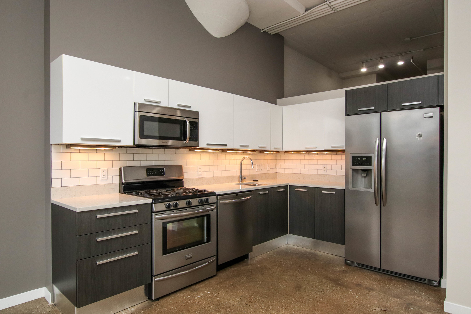 1313 West Randolph Street, Unit 203 Chicago, IL 60607 - Photo 4 of 18 a kitchen with a stove microwave and refrigerator