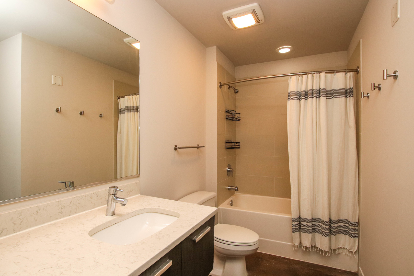1313 West Randolph Street, Unit 203 Chicago, IL 60607 - Photo 8 of 18 a bathroom with a sink toilet tub and shower