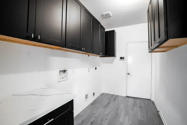 a room with a sink and cabinets