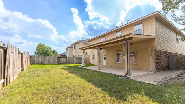 a view of a house with backyard and a small cabin