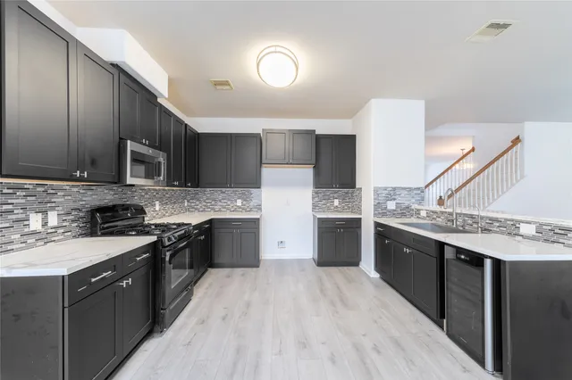 a large kitchen with a stove top oven