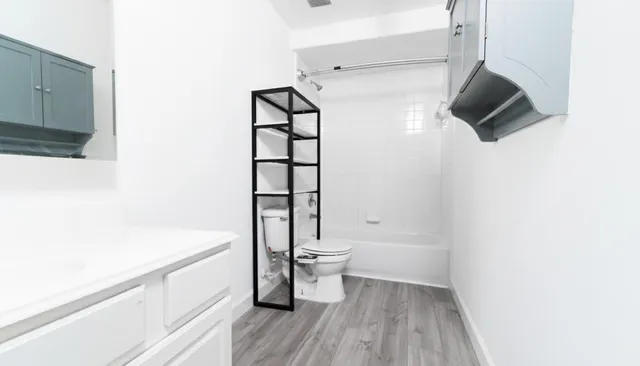 a bathroom with a bathtub and a toilet