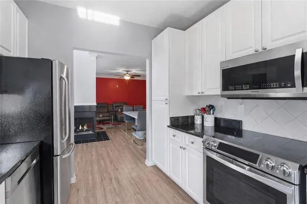 a kitchen with a refrigerator stove and microwave