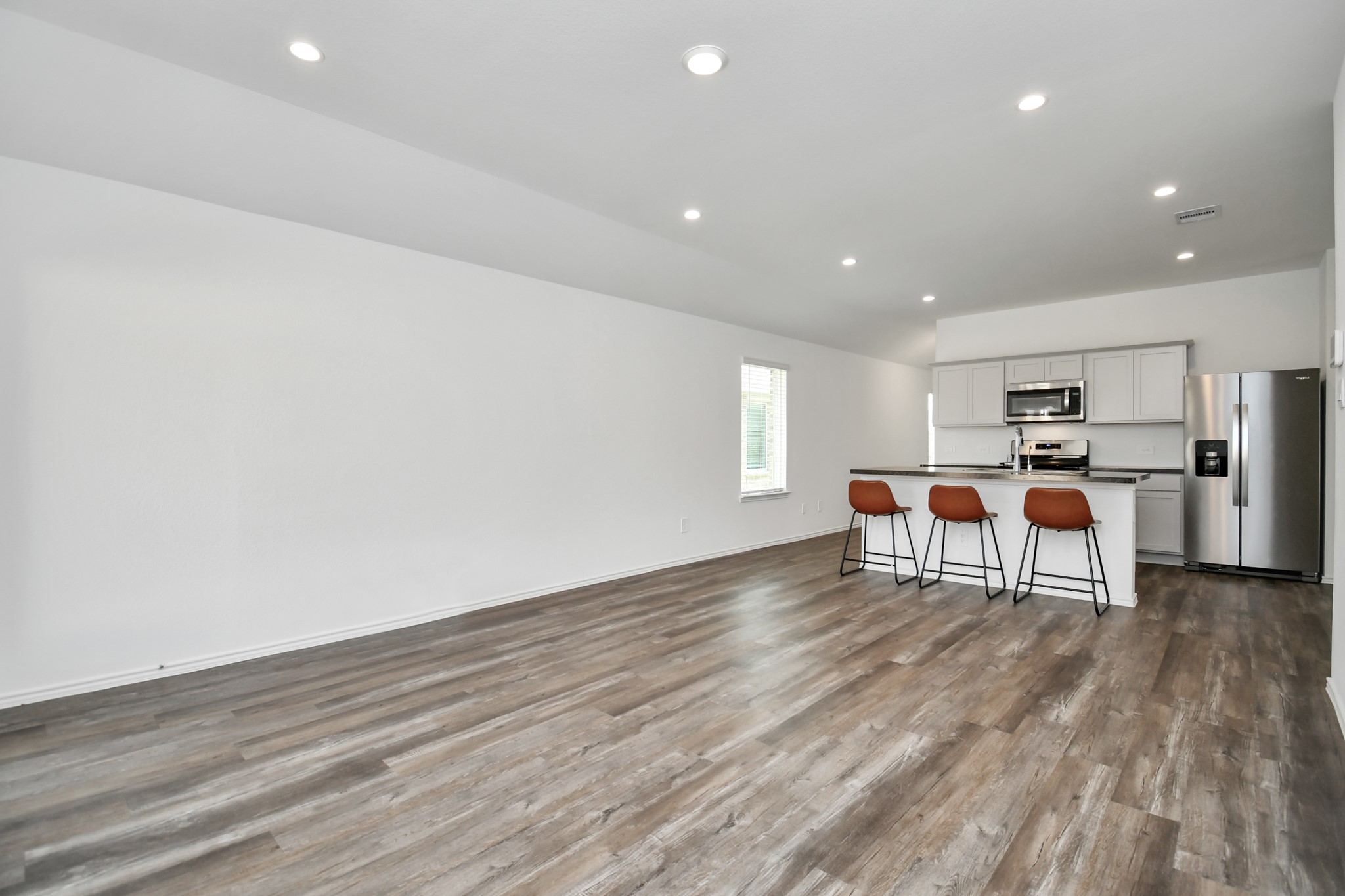 5315 Castlebury Meadows Dr Spring Spring, TX 77373 - Photo 14 of 39 a living room with stainless steel appliances kitchen island furniture and wooden floor