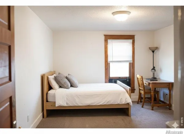 a bedroom with a bed and a table