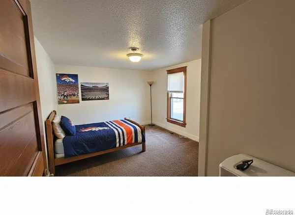 a bedroom with furniture and window
