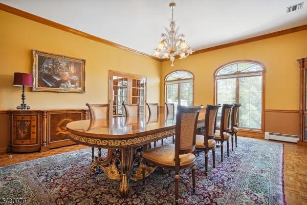 a view of a dining room with furniture and chandelier