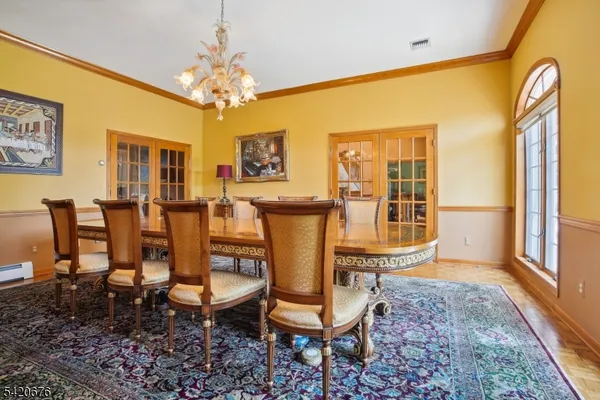 a dining room with chairs window and wooden floor