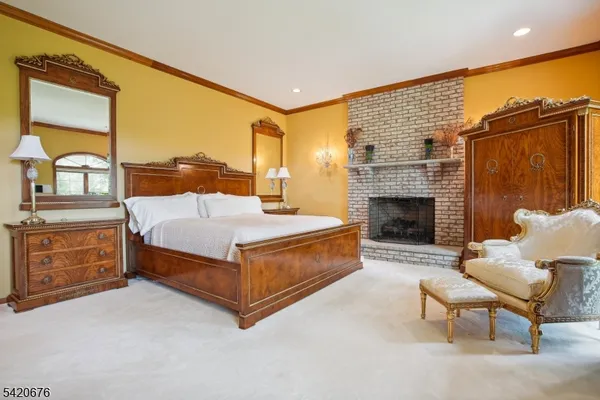 a bedroom with a bed and a fireplace