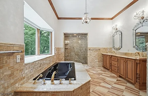 a bathroom with a granite countertop sink a mirror and a bathtub