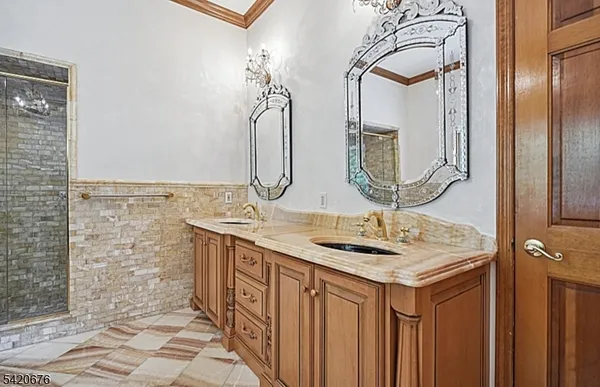 a bathroom with a sink a mirror and a shower