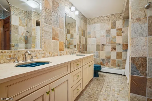 a spacious bathroom with double vanity and a bathtub