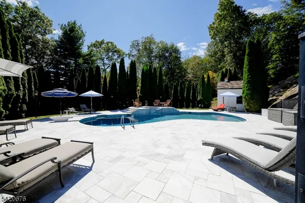 a view of a backyard with sitting area