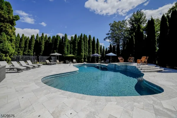 a view of a swimming pool with sitting area