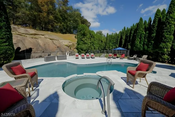 swimming pool view with a seating space